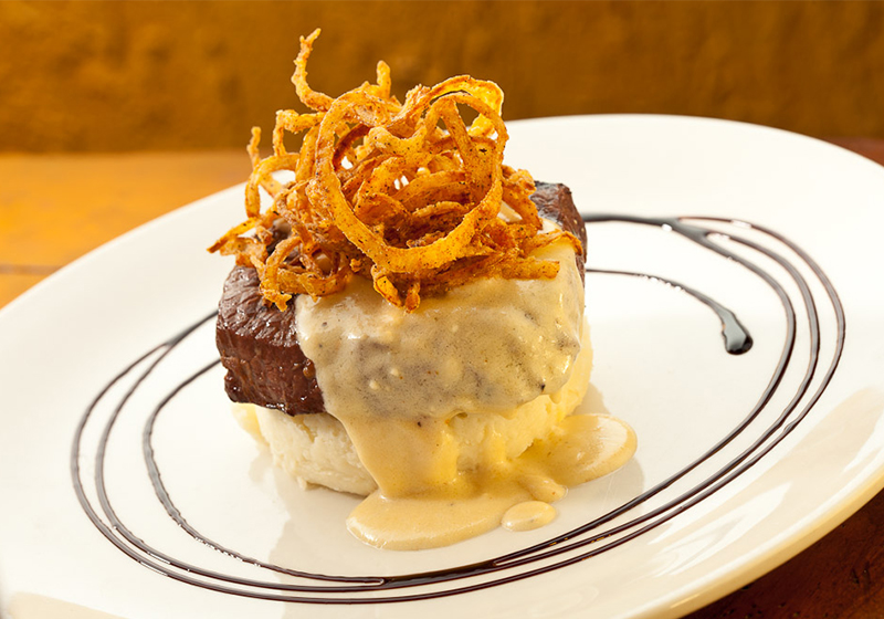 Steak with mashed potatoes and fried onions